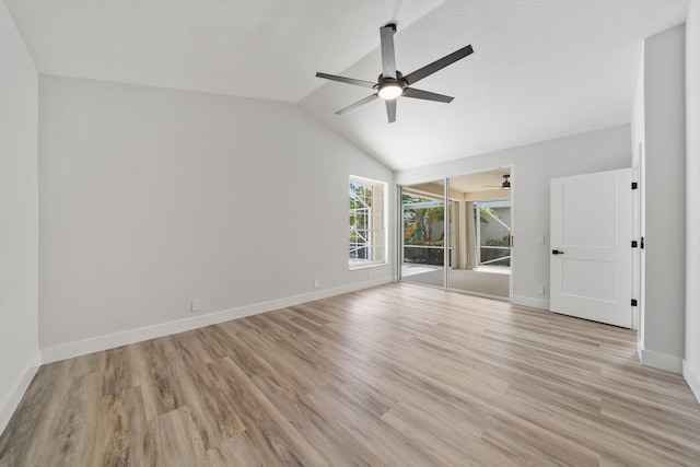 unfurnished room with a textured ceiling, light hardwood / wood-style flooring, ceiling fan, and lofted ceiling