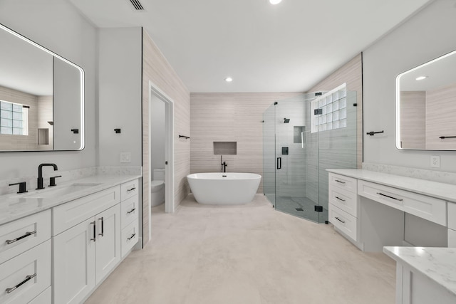 full bathroom with shower with separate bathtub, vanity, and toilet