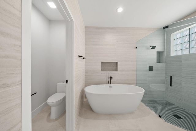 bathroom with separate shower and tub, tile patterned flooring, tile walls, and toilet