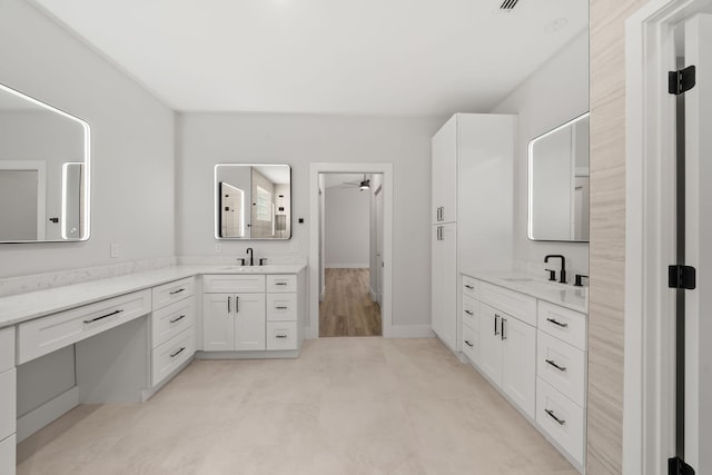 bathroom featuring wood-type flooring, vanity, and ceiling fan