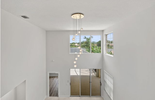 staircase with hardwood / wood-style floors and a textured ceiling