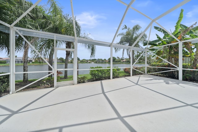 unfurnished sunroom with a water view