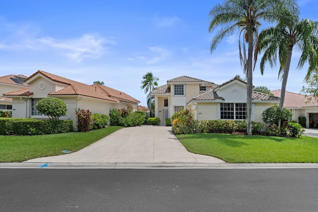 mediterranean / spanish-style home with a front lawn