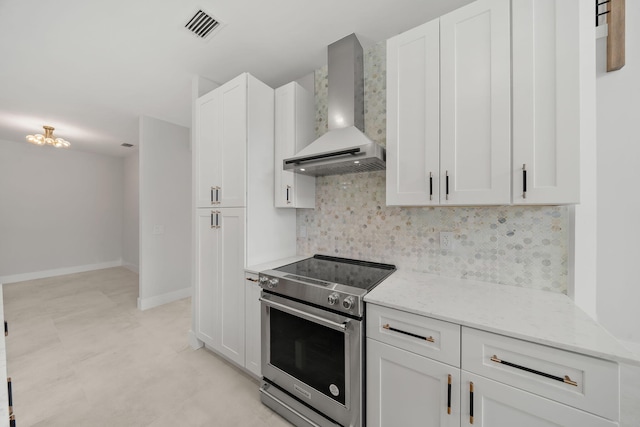 kitchen with white cabinetry, light stone countertops, wall chimney range hood, backsplash, and stainless steel electric range