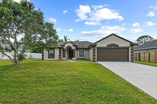 ranch-style home with a garage and a front lawn