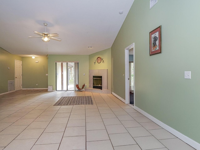 unfurnished living room featuring ceiling fan, light tile patterned flooring, lofted ceiling, and a fireplace