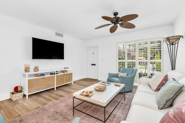 living room with ceiling fan, hardwood / wood-style floors, and crown molding