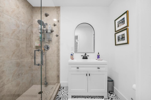 bathroom featuring tile patterned flooring, vanity, and walk in shower