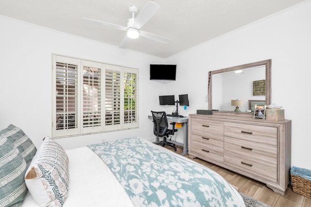 bedroom featuring ceiling fan, crown molding, and light hardwood / wood-style flooring