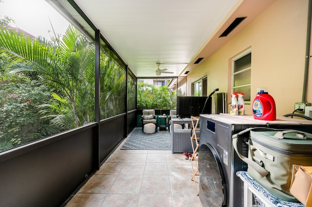 sunroom / solarium featuring ceiling fan and washer / dryer