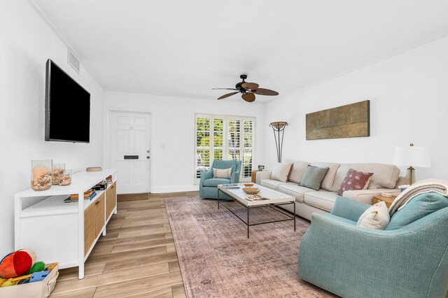 living room with light hardwood / wood-style flooring and ceiling fan