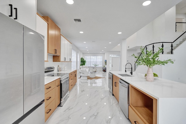 kitchen with light brown cabinetry, sink, wine cooler, and appliances with stainless steel finishes