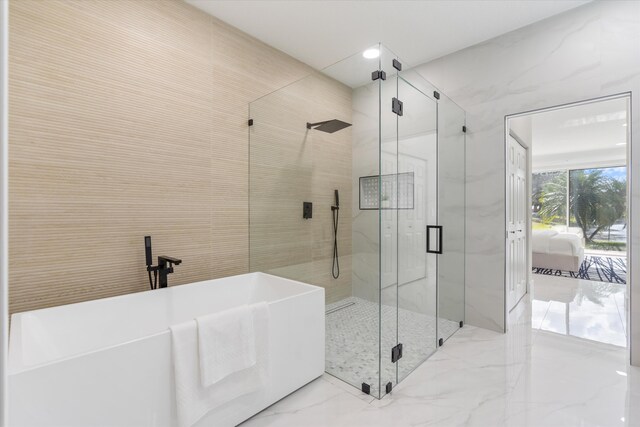 bathroom featuring shower with separate bathtub