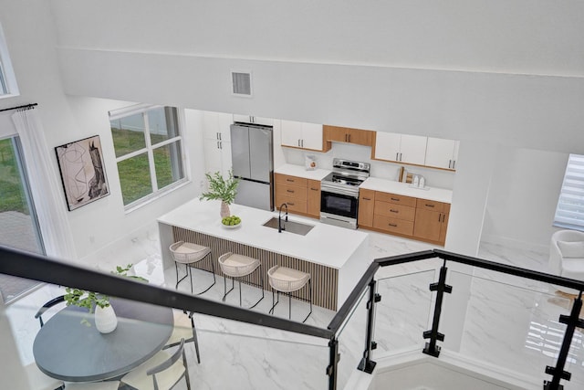 kitchen with white cabinetry, sink, and appliances with stainless steel finishes