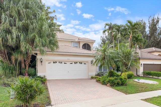 mediterranean / spanish house featuring a garage