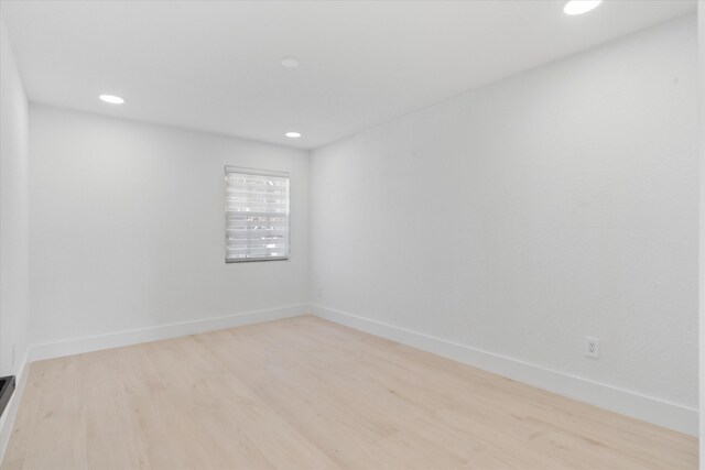 spare room with light hardwood / wood-style floors