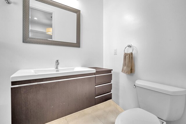 bathroom featuring tile patterned floors, vanity, and toilet