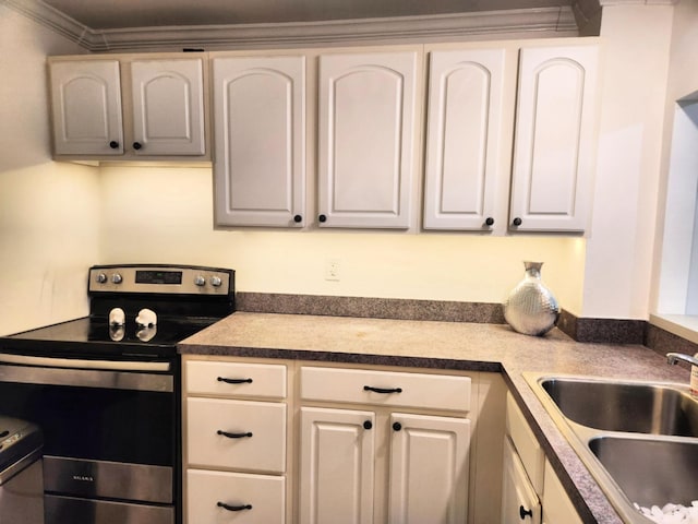 kitchen with electric stove, sink, white cabinets, and ornamental molding