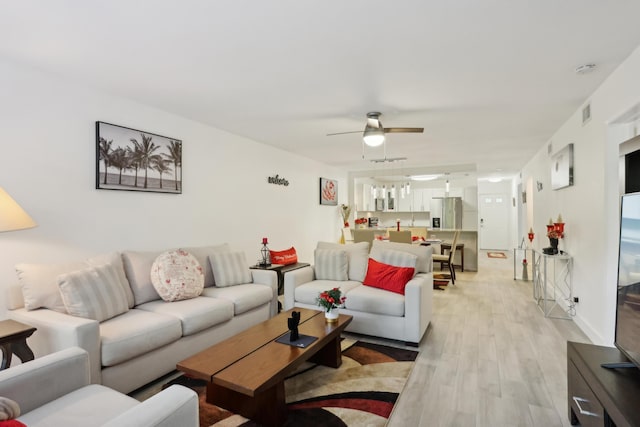 living room featuring ceiling fan and light wood-type flooring