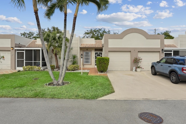 view of front facade with a front yard and a garage