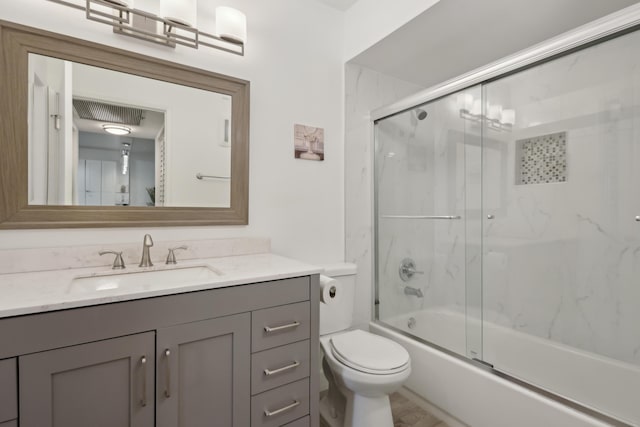 full bathroom featuring vanity, toilet, and bath / shower combo with glass door