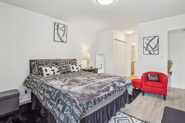 bedroom featuring hardwood / wood-style floors and ensuite bathroom