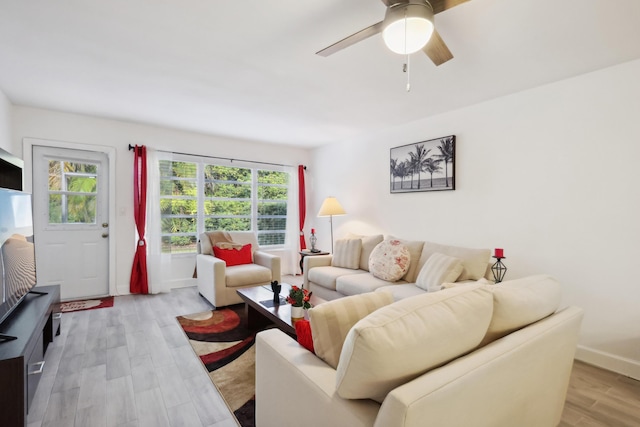 living room with ceiling fan and light wood-type flooring