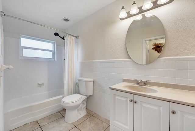 full bathroom featuring tile patterned floors, tile walls, shower / tub combo, and toilet