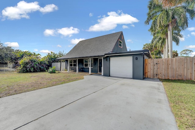 view of front of home with a garage and a front yard