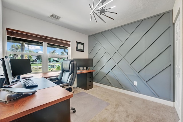 home office with light colored carpet, a textured ceiling, and an inviting chandelier