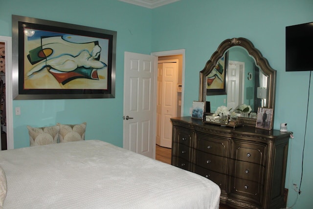 bedroom featuring hardwood / wood-style floors and crown molding