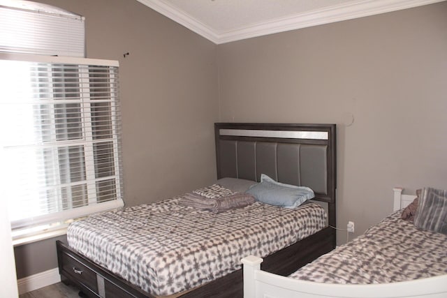 bedroom with ornamental molding and hardwood / wood-style flooring