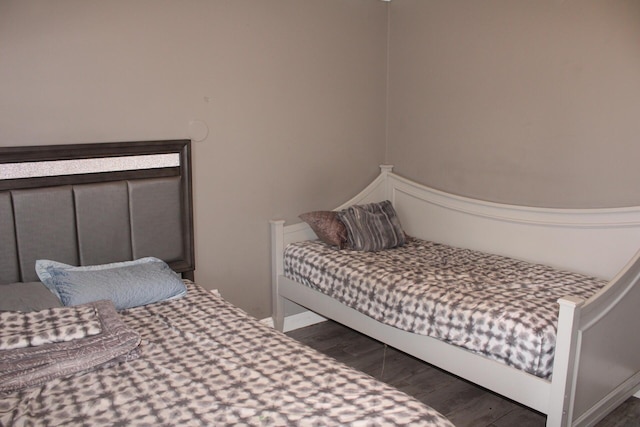 bedroom with dark hardwood / wood-style flooring