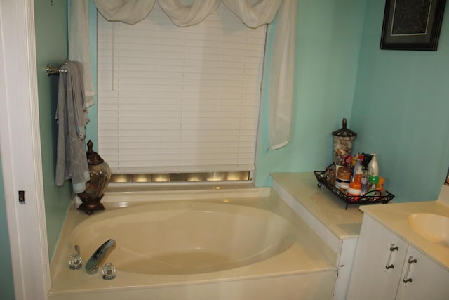 bathroom with vanity and a bath