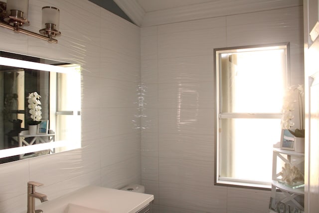 bathroom featuring sink and tile walls