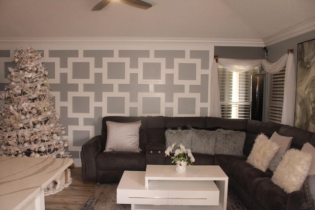 unfurnished living room featuring hardwood / wood-style floors, ceiling fan, ornamental molding, and a textured ceiling