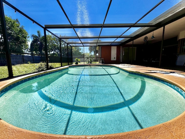 view of pool featuring a lanai, a patio area, a fenced in pool, and fence