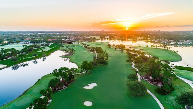 aerial view at dusk featuring a water view