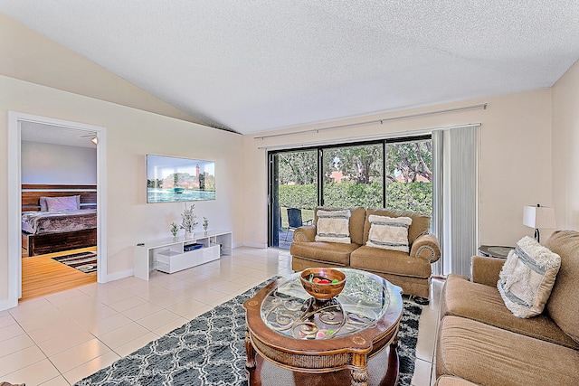 tiled living room with a textured ceiling and vaulted ceiling