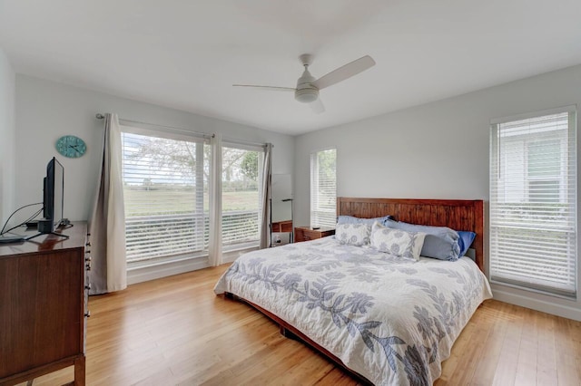 bedroom with ceiling fan, access to exterior, and light hardwood / wood-style flooring