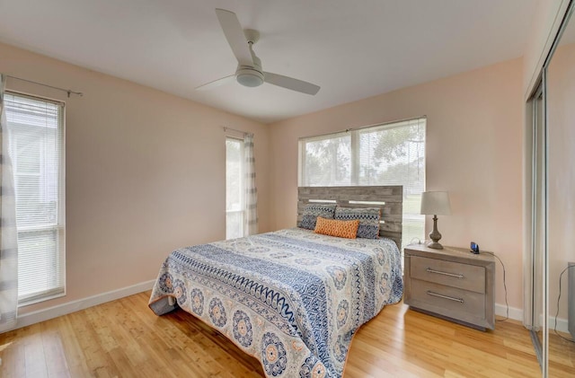 bedroom with ceiling fan, light hardwood / wood-style flooring, and a closet