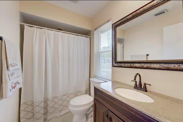 bathroom featuring toilet and vanity