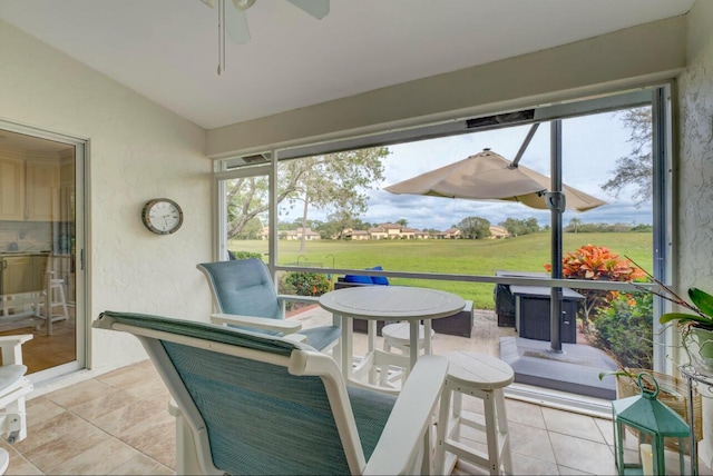 sunroom featuring ceiling fan and lofted ceiling