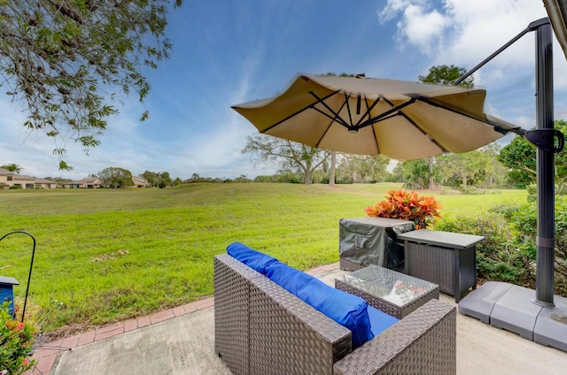 view of patio / terrace featuring an outdoor living space and a rural view