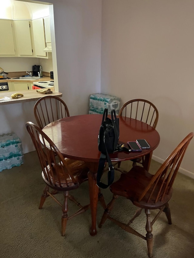 dining space featuring light carpet