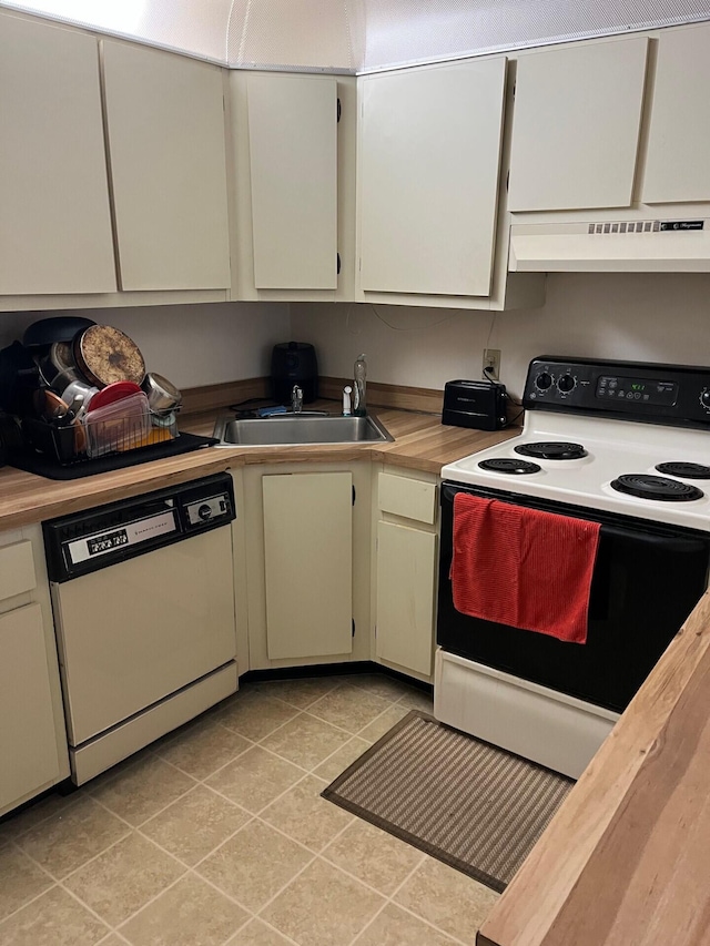 kitchen with white cabinetry, sink, white appliances, and light tile patterned flooring