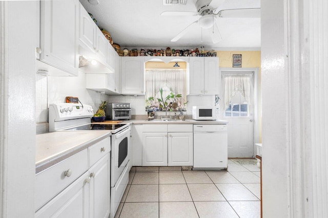 kitchen with white appliances, white cabinets, ceiling fan, light tile patterned floors, and sink