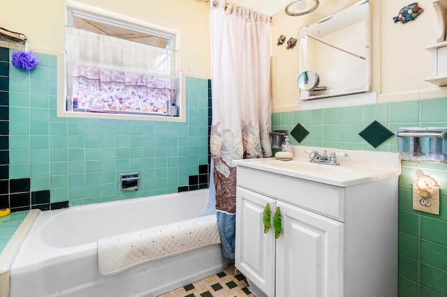 bathroom featuring tile walls, vanity, and shower / tub combo with curtain