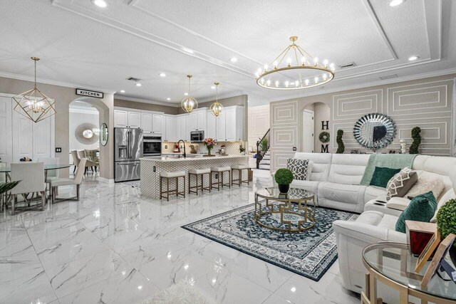 kitchen featuring kitchen peninsula, white cabinetry, stainless steel appliances, and decorative light fixtures