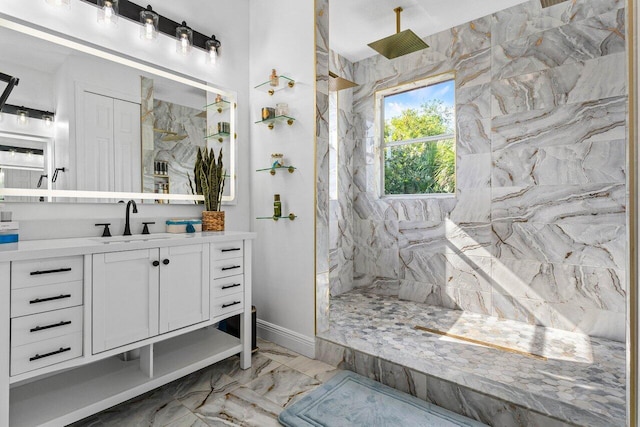 bathroom with a marble finish shower, marble finish floor, vanity, and baseboards